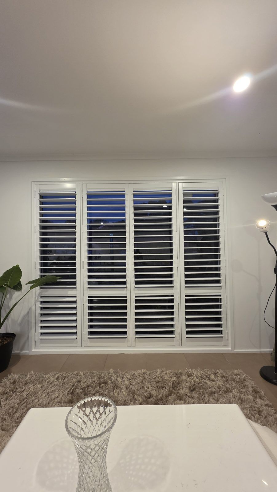 Corner window shutters photographed in the evening