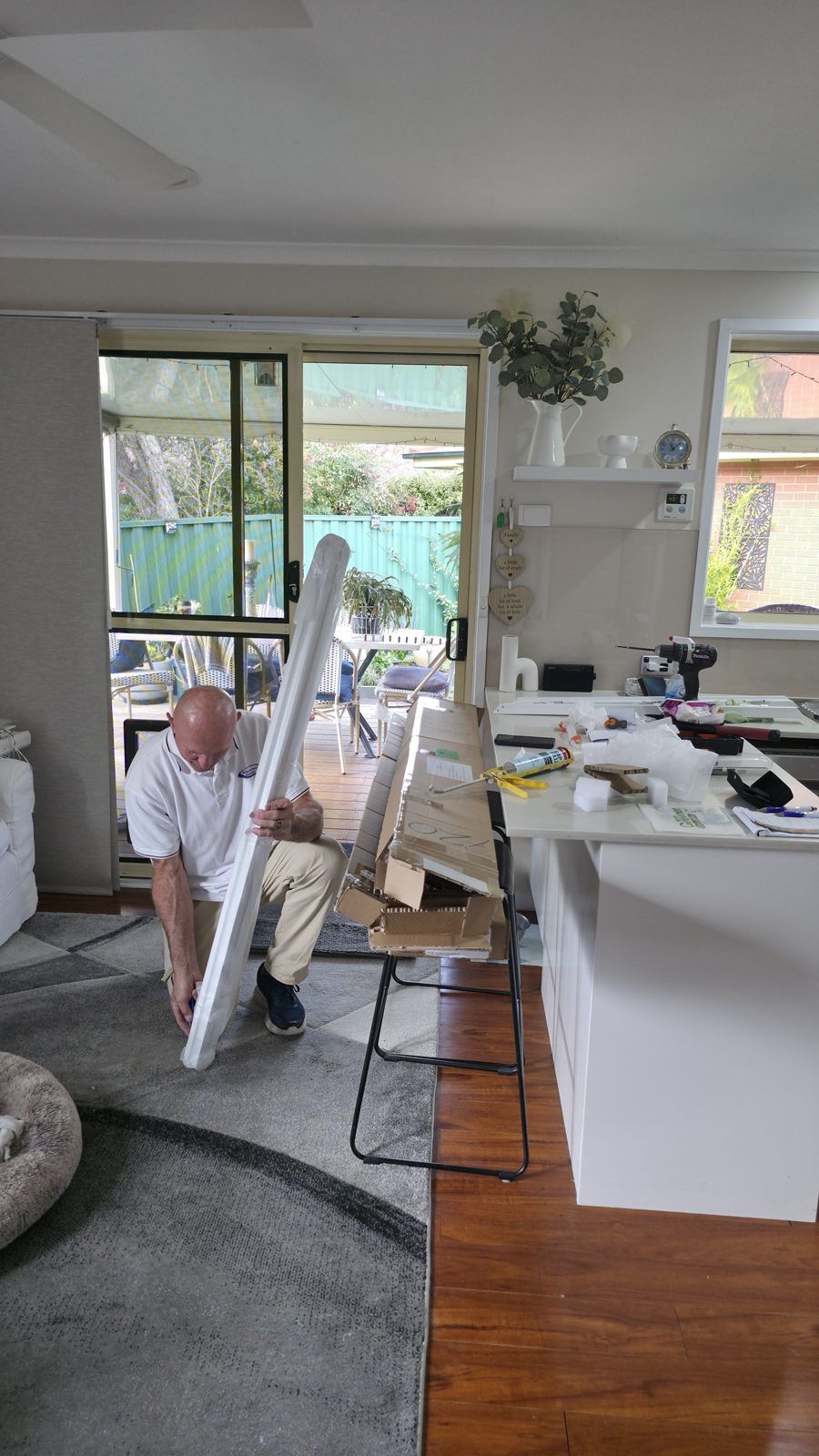 Stefan from shuttersforvalue carrying a shutter panel during a Canberra installation